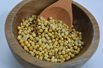 Coriander Seeds in Wood Bowl Isolated, Cilantro Grain, Chinese Parsley Seed Group, Dry Spices, Seasonings, Coriander Herb on White Background 
