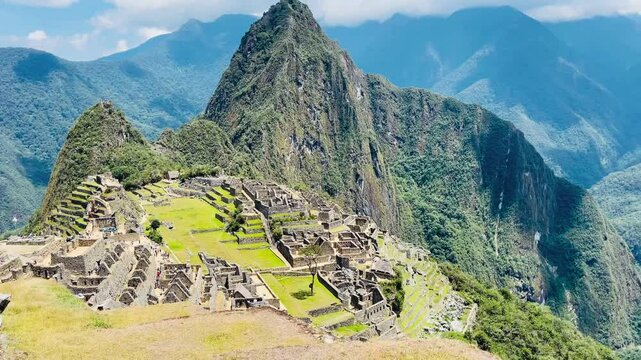 Scenic shot of historic Machu Picchu city with clear skies and greenery, Peru