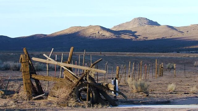 In a remote mountain valley of California's southern Sierra Nevada mountains, the last rays of the sun withdraw from the landscape shadow falls on a crude and rustic barbwire fence.