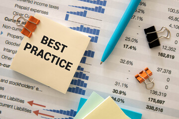 best practice text on a notepad with a spiral. cup of coffee