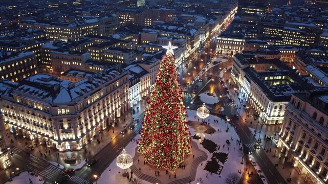 Christmas tree illuminating snowy syntagma square in athens