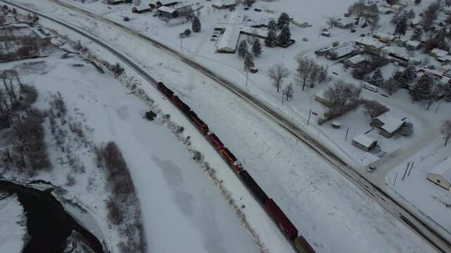Over a train in winter small town and river 