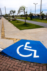 Accessible sidewalk with ramp and signage for people with disabilities (PWD). Illustrates inclusion...