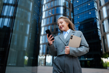 Businesswoman Enjoys a Moment of Connection While Strolling Through a Modern Urban Landscape,...