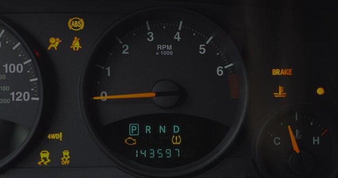 Close-up of car dashboard with multiple warning lights activated, including ABS, airbag, seatbelt, brake, 4WD, and tire pressure. Gear in Drive, RPM at idle. Vehicle maintenance concept. 