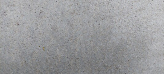 Superficie de concreto con una textura uniforme, su color es gris claro, sin elementos adicionales visibles.