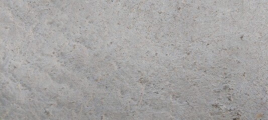 Superficie de concreto con una textura uniforme, su color es gris claro, sin elementos adicionales visibles.