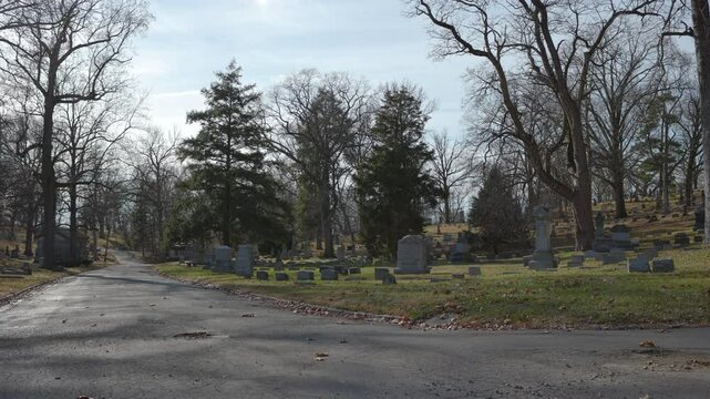 Wide angle view of road through graveyard 4k
