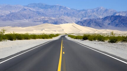Naklejka premium Desert highway stretches into a vast mountain range.