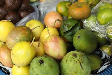 Different fresh exotic fruits at market, closeup