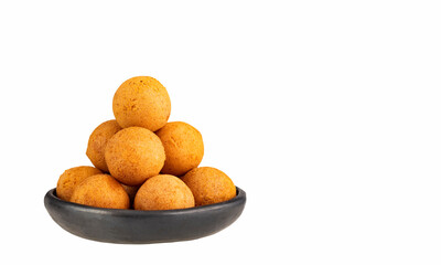 Fried cheese buñuelos on a plate on a white background - Colombian food