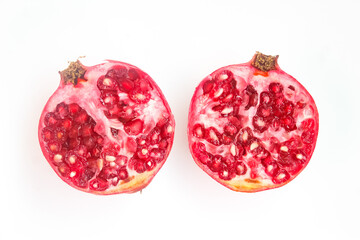 halved pomegranate isolated on white background