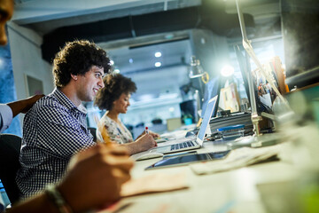 Team collaborating on creative project in modern office workspace