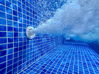 Underwater view of the pool mosaic tile and water jets