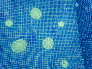 Underwater view of the pool mosaic tile and water jets