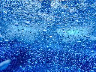Underwater view of the pool mosaic tile and water jets