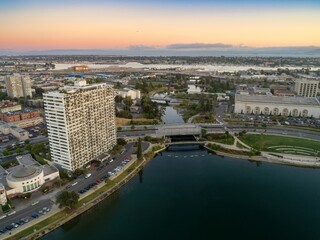 Aerial view of Lake Merritt Oakland, California, USA, at dusk. The image captures the city's skyline, Lake Merritt, and surrounding urban landscape, showcasing the city's beauty.