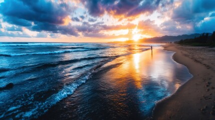 Obraz premium Dramatic sunset over a beach, with a lone figure walking along the shore
