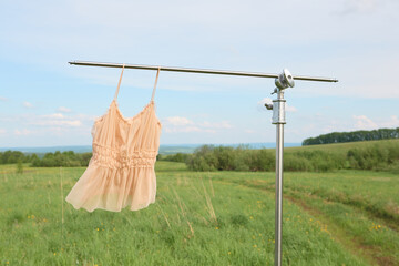Elegant summer dress hanging outdoors on a clothesline