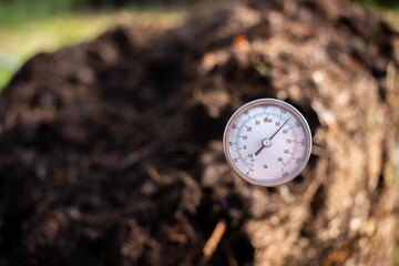 farmer collecting soil samples in a test tube in a field. Agronomist checking soil carbon and plant health on a farm