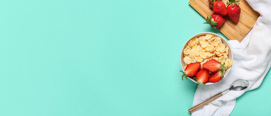 Bowl of tasty cornflakes and strawberry on turquoise background with space for text