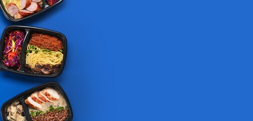 Containers with healthy food on blue background with space for text