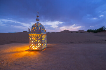 Sunset views of lanterns lit up I the dark at a desert camp in Erg Chebbi sand dunes located in Morocco on the western edge of the Sahara Desert