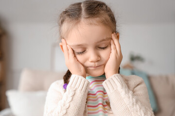 Little girl with headache at home