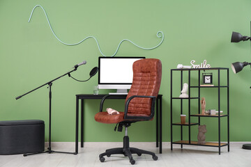 Interior of recording studio with workplace, microphone and shelf unit