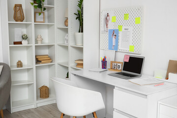 Interior of office with workplace, pegboard and to-do list