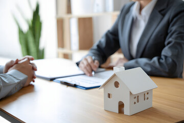 Real estate agent signing documents with client