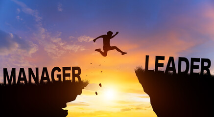 Silhouette man jumping from MANAGER to LEADER wording on cliffs with cloud sky and sunrise. Go ahead and Keep go on to success Concept.