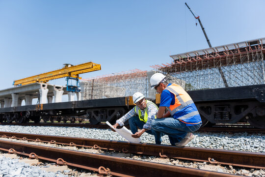 Engineers Discussing Project Progress at Construction Site,  Civil Engineers in Safety Gear at Industrial Building Site, Construction Workers Planning Infrastructure Development - Powered by Adobe