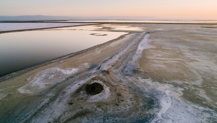 Aerial view of salt ponds in Fremont , California, USA, at dawn. The ponds are used for salt production, and the different colors indicate varying salinity levels.
