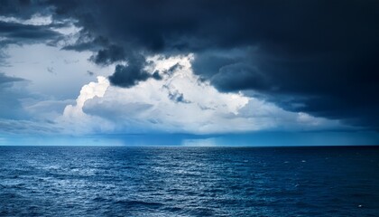 Obraz premium dark with dramatic blue sky and dark as dramatic blue sea color and dark storm raining cloud background