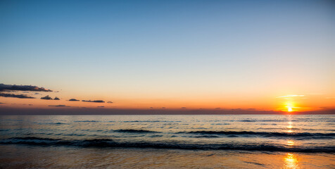 Sunset over the ocean with a clear sky and calm water.premium photo of sea and sun view for background