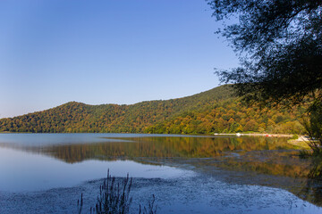 Azerbaijan Lake Shimmering Reflects Autumn Hues on Hills