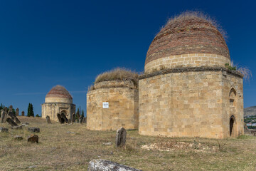 Historical Azerbaijani Mausoleums Stand Tall Under Bright Blue Sky