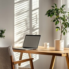 Fototapeta premium Minimalist Scandinavian home office with laptop on wooden desk, coffee mug, indoor plant, cozy chair and white walls, bathed in soft natural daylight, remote work concept with shallow depth of field