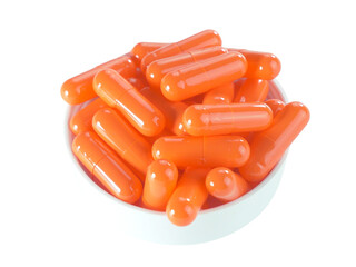 Bulk orange capsule pills on a white tray isolated on white background.