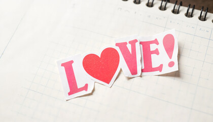 Love letters cutout on notebook page in playful design  