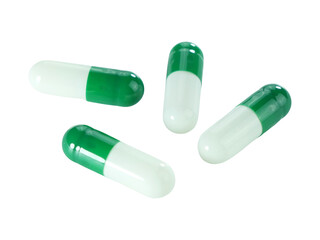 Bulk green and white capsule pills isolated on white background.