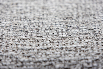 close-up shot of a tightly woven fabric with a mix of light gray and darker threads