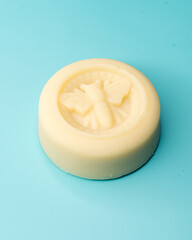 honey bee soap against blue background