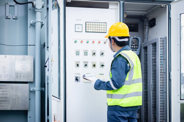 Engineer is working on high voltage power substation inspection to check infrastructure and ensure safety and functionality of electrical system