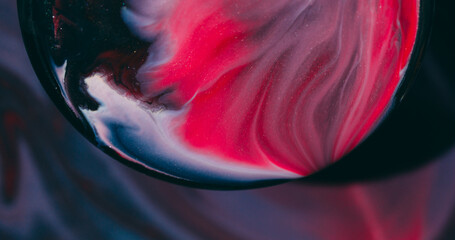 Art liquid. Blur glitter paint. Red blue black emulsion blend in round lens. Swirl flow spilling on...