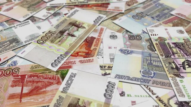 A large pile of scattered russian ruble banknotes, HD footage.