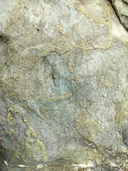 Textured stone background with rough rock wall surface, abstract natural grunge detail of stone material