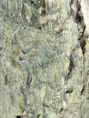 Textured stone background with rough rock wall surface, abstract natural grunge detail of stone material