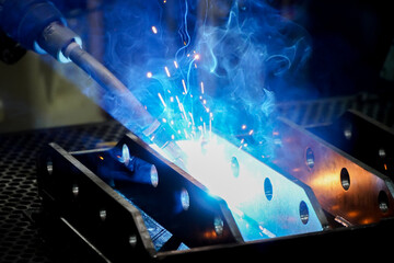 Industrial robots are welding,movement of robots welding automotive parts.